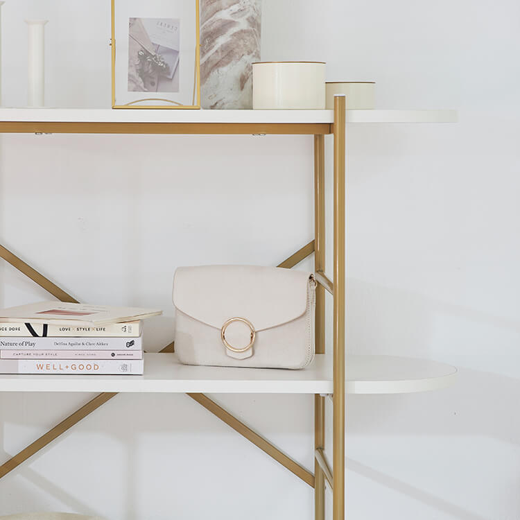 A stylish open shelf in white and gold with 3 tiers
